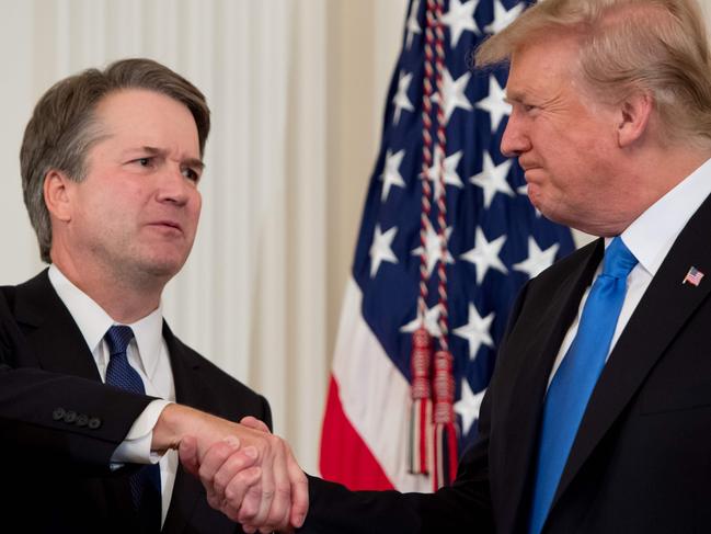 US Judge Brett Kavanaugh (L) shakes hands with US President Donald Trump after being nominated to the Supreme Court in the East Room of the White House on July 9, 2018 in Washington, DC.  / AFP PHOTO / SAUL LOEB