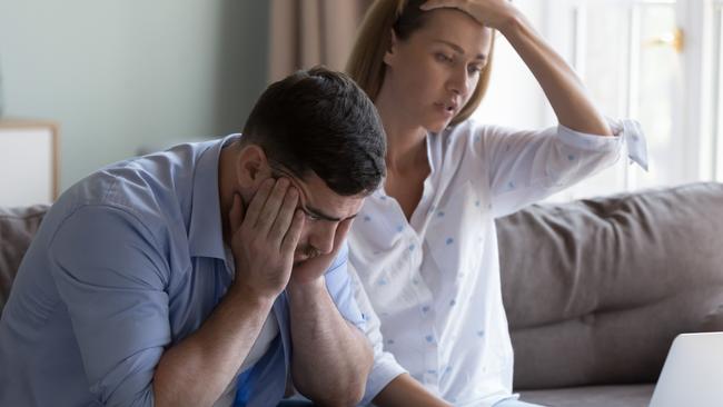 Stressed spouses manage family finances, analyze expenses, check savings and budget, looks disappointed due to mortgage arrears, unpaid utility bills, debt notice. Lack of money, high utility concept