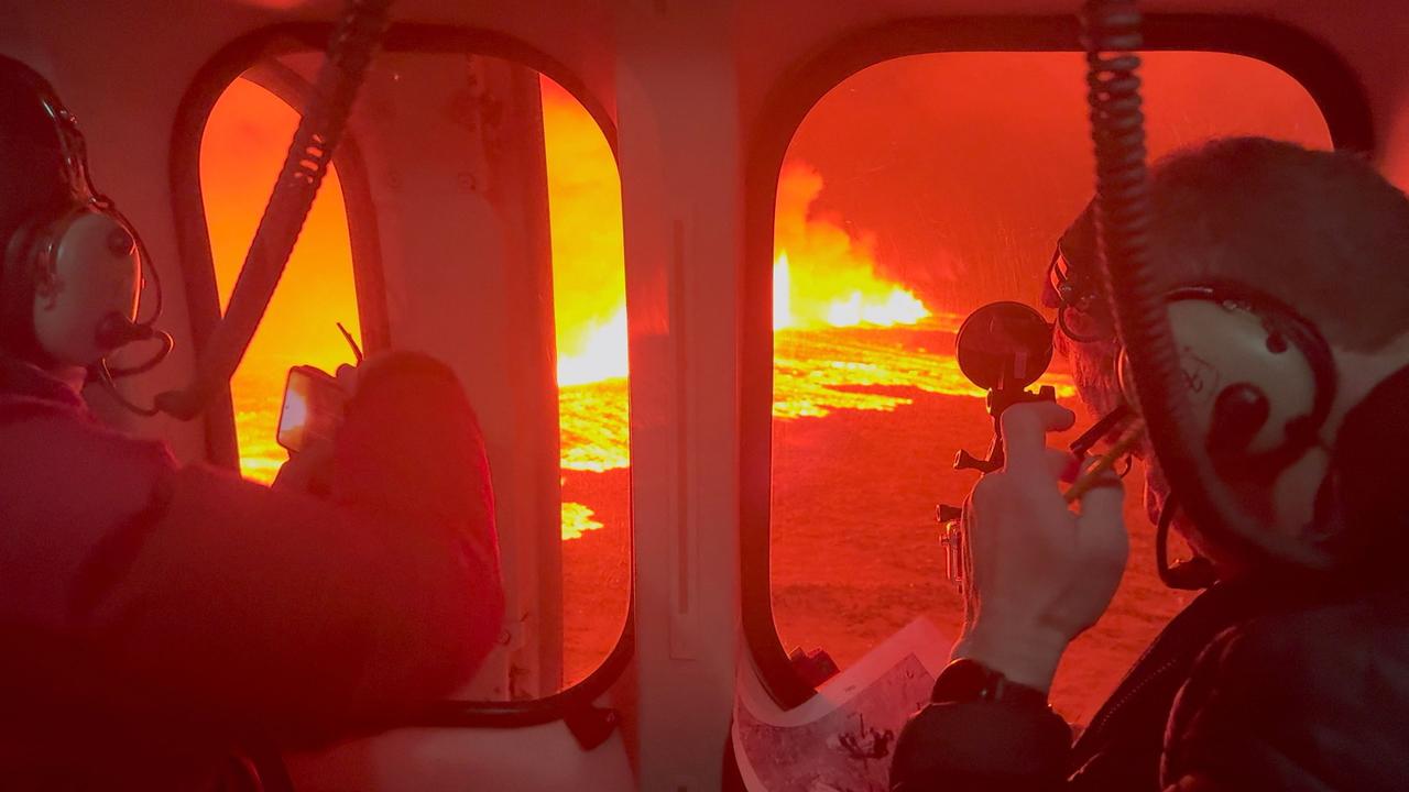 Emergency personnel and scientists observe the eruption from a Coast Guard helicopter. Picture: Icelandic Coast Guard/AFP