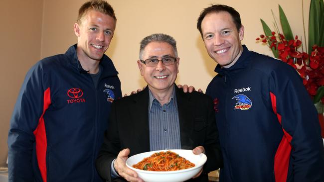 Adelaide Crows players Nathan van Berlo and Brenton Sanderson with Enzo at Enzo's restaurant.