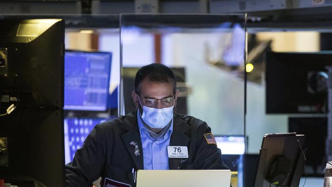 A trader works on the partially reopened NYSE trading floor. Picture: AP