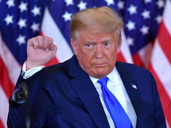 (FILES) In this file photo US President Donald Trump pumps his fist after speaking during election night in the East Room of the White House in Washington, DC, early on November 4, 2020. - The US election was plunged into chaos early November 4, 2020 as President Donald Trump prematurely declared victory and sought Supreme Court intervention to stop vote-counting -- even as his Democratic rival Joe Biden voiced confidence in his own chances. In a divisive election cast under the shadow of the coronavirus pandemic that has claimed more than 230,000 lives in the United States, Trump appeared to have avoided a Democratic wave predicted by some polls but he still needs key states to secure another four-year term. (Photo by MANDEL NGAN / AFP)