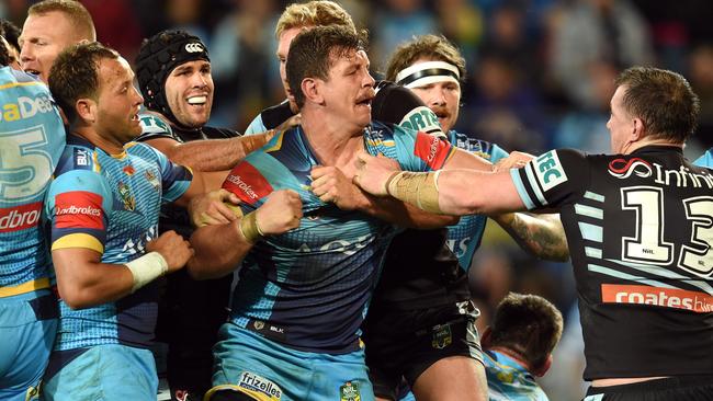 Paul Gallen and Greg Bird clash during the Sharks-Titans match at Cbus Super Stadium.