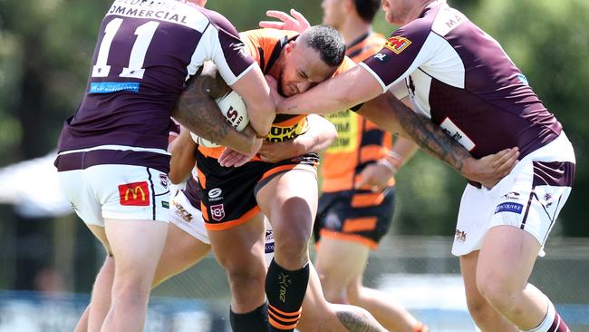 Eni Folau takes a hit up against Burleigh. Picture by Richard Gosling