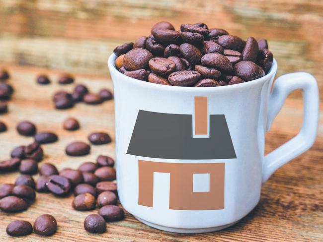 White coffee cup filled with coffee beans on rustic wooden table.