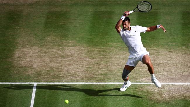 Serbia's Novak Djokovic returns against Italy's Lorenzo Musetti during their men's singles semi-final tennis match.