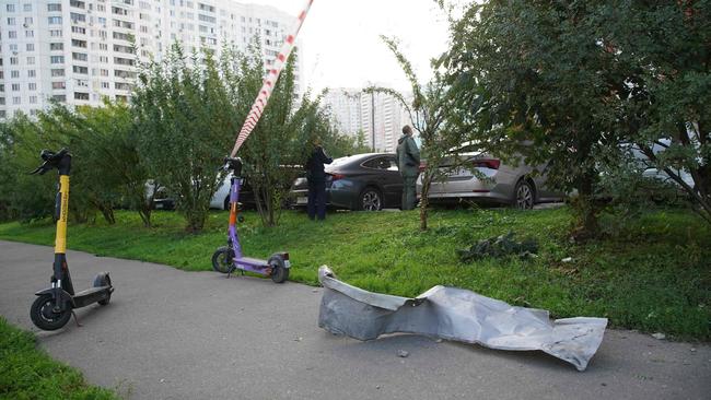 Local residents stand next to debris following a drone attack in Krasnogorsk, in the Moscow region, on August 22. Picture: AFP