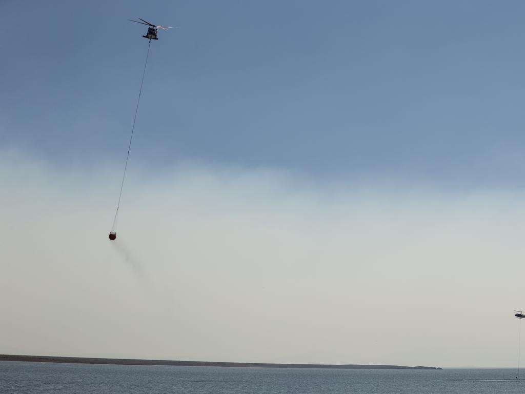 A wall of smoke obscures the view of water-bombing aircraft tackling the Miena blaze. Picture: Heath Holden/Getty