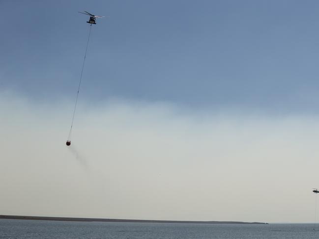 A wall of smoke obscures the view of water-bombing aircraft tackling the Miena blaze. Picture: Heath Holden/Getty