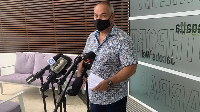 A masked Gold Coast Mayor Tom Tate addresses media. Picture: Greg Stolz