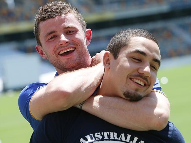 UFC fighter Rob Whittaker is put in a rear-naked choke by Brisbane Lions player Pearce Hanley. Picture: Peter Wallis.