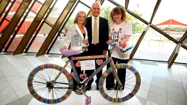 PM Malcolm Turnbull and his wife Lucy, left, and Sydney-based “yarn bomber” Eloise Murphy, with the Love Wheels bicycle she crocheted, at the National Museum of Australia in Canberra. Picture: Kym Smith.