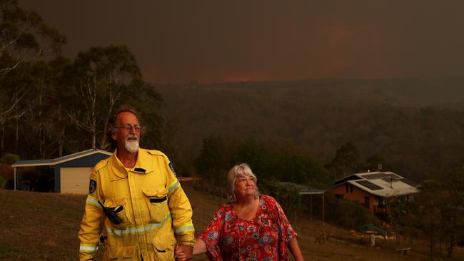 John and Karen McMahon watch from their home as the Big Jack Mountain fire gathers intensity. Picture: Toby Zerna