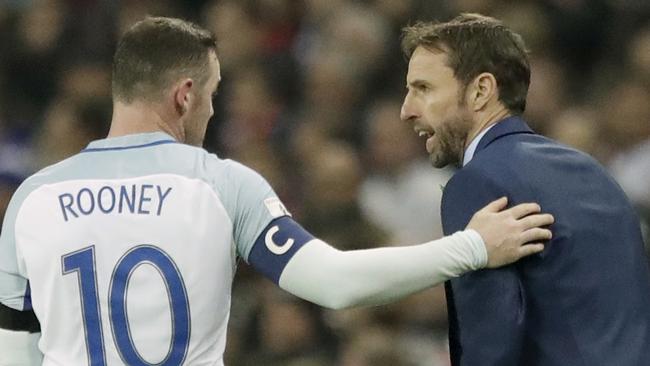 England's Wayne Rooney (L) talks to England's interim manager Gareth Southgate.