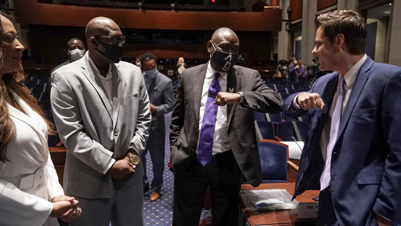 Angela Underwood Jacobs, left, and Philonise Floyd, watch as Ben Crump, civil rights lawyer representing George Floyd’s family, second from right, elbow bumps Representative Matt Gaetz. Picture: Greg Nash/Pool via AP