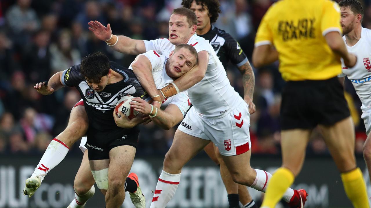 Brandon Smith is tackled by Tom Burgess and George Burgess. (Photo by Michael Steele/Getty Images)