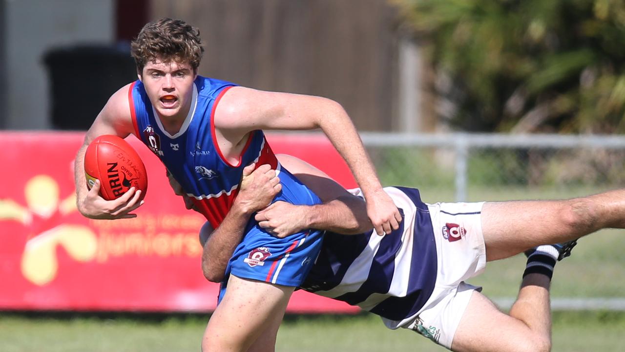 Jaiden Butson is wrapped up by Ethan McCollough in the AFL Cairns seniors match between Centrals Trinity Beach Bulldogs and Port Douglas Crocs, held at Crathern Park, Trinity Beach. Picture: Brendan Radke