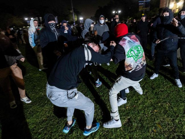 A pro-Palestinian demonstrator is beaten by counter protesters attacking a pro-Palestinian encampment set up on the campus of the University of California Los Angeles. Picture: AFP