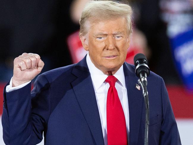 US President and Republican presidential candidate Donald Trump gestures while speaking during a campaign rally at the J.S. Dorton Arena in Raleigh, North Carolina, on November 4, 2024. Bitter rivals Kamala Harris and Donald Trump embark on a final frenzied campaign blitz Monday with both hitting must-win Pennsylvania on the last day of a tight and volatile US presidential election campaign. (Photo by Ryan M. Kelly / AFP)