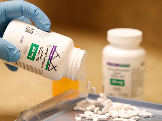 A pharmacy tech pours out pills of Hydroxychloroquine at Rock Canyon Pharmacy in Provo, Utah, on May 20, 2020. - US President Donald Trump announced May 18 he has been taking hydroxychloroquine for almost two weeks as a preventative measure against COVID-19. (Photo by GEORGE FREY / AFP)