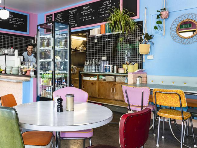 The funky, bright interior at Moonah’s Plain Jane features gelato-bright painted walls, original Laminex tables, vintage china and comfy pastel upholstered benches. Picture: Linda Higginson