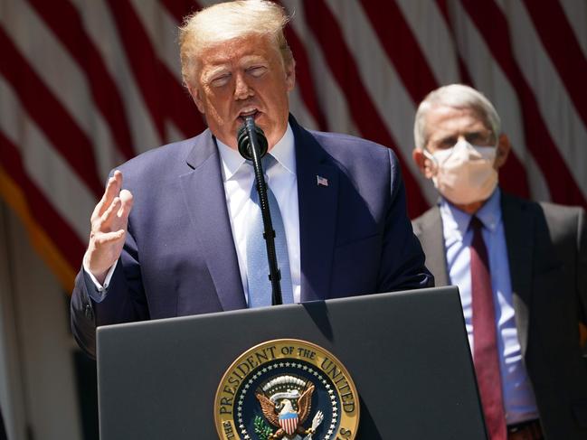 US President Donald Trump speaks to the press as Dr Anthony Fauci watches on. Picture: AFP