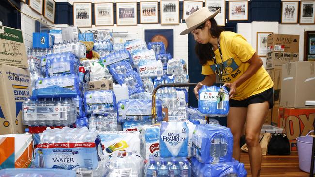 Volunteer Yaya Stempler loads water bottles onto a trolley. Bondi Surf Bathers Life Saving Club has been inundated with donations after setting up as a bushfire relief centre. Picture: John Appleyard