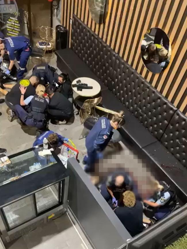 Police and paramedics tend to the victims.