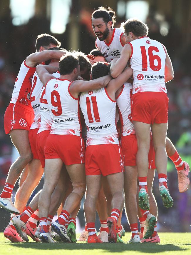 His teammates celebrated both his goals in fine style. Picture: Brett Costello