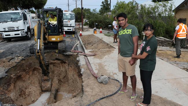 Nithin Mathai and Anjali Thomas-Mathai in front of their Seacombe Gardens unit which was flooded after a water main burst on January 26.