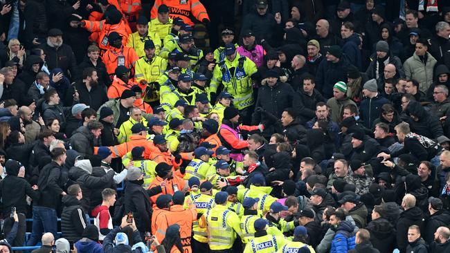 Police and stewards hold back fans of both Manchester City and Feyenoord. Picture: Michael Regan/Getty Images