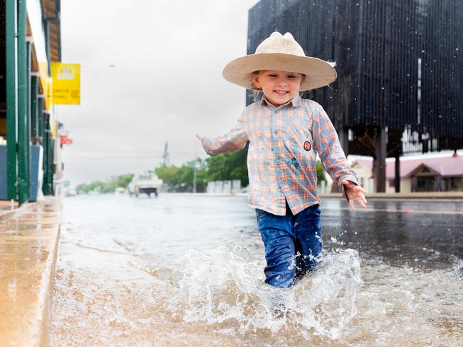 Hudson Nicol playing in puddles in Barcaldine on Tuesday. Picture: Aaron Skinn