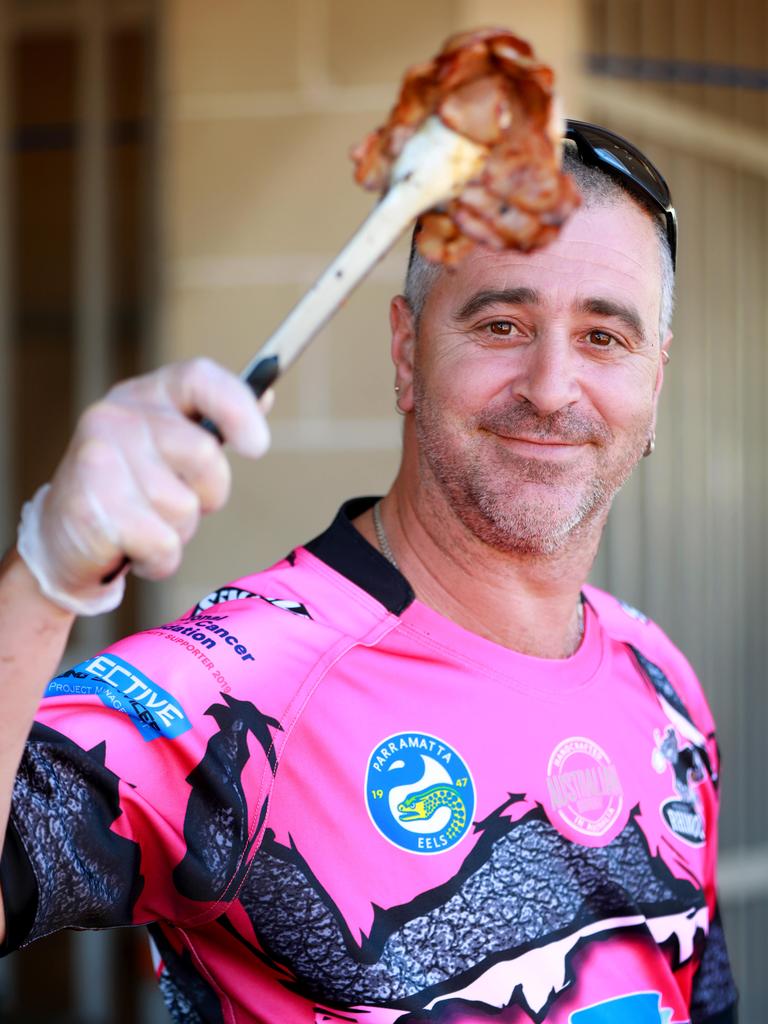 Dave Calandrucciohas BBQ duty at the Rouse Hill Rhinos Pink Day in Kellyville. (AAP IMAGE / Angelo Velardo)