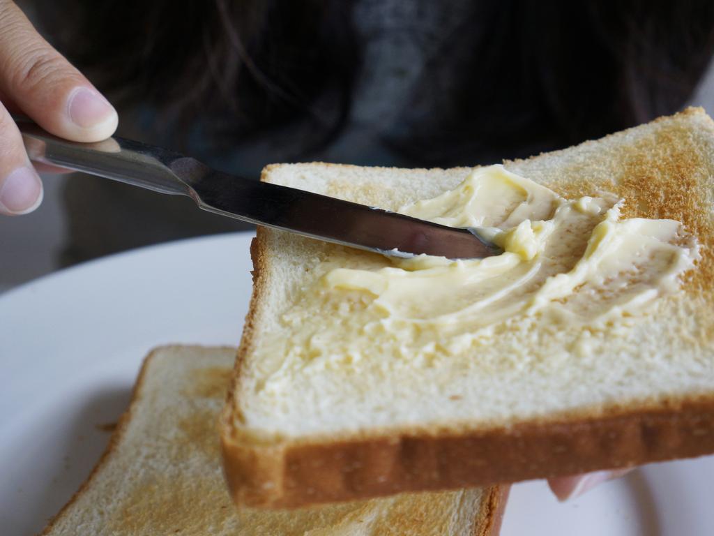 buttering toast with knife