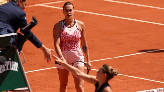 Marta Kostyuk of Ukraine shakes hands with the umpire before avoiding shaking hands with Aryna Sabalenka at Roland Garros. Photo by Julian Finney/Getty Images