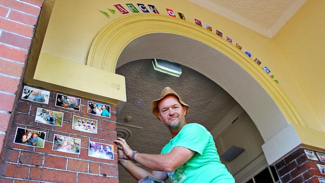 Photographer Paul Neil shown installing prints in the Arch of Sandgate at Sandgate Town Hall for last year's retrospective exhibition of his work. Picture: Ian Fraser