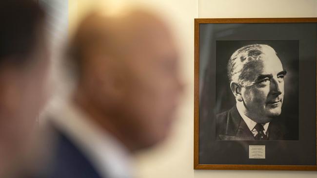 A portrait of Sir Robert Menzies hangs on the wall next to Peter Dutton.