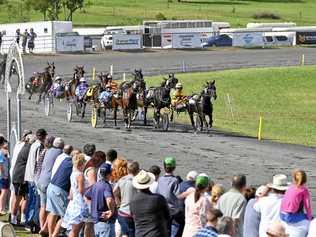 GREAT VIEWING: Racegoers watch intently as drivers jostle for prime position in one of the races at the Easter Sunday meeting at Marburg. Picture: Cordell Richardson