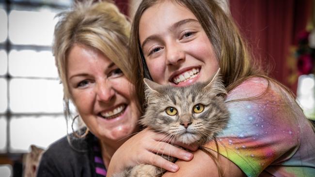 Willow the Cat was found in Clayton 22 months after she disappeared from her owners' place in The Basin. She’s pictured with Julianne Beck and her daughter Sienna. Picture: Jake Nowakowski