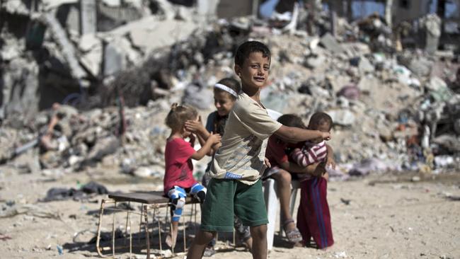 Palestinian children play next to the rubble of buildings that were destroyed during last year’s 50-day war. Picture: AFP / Mohammed Abed