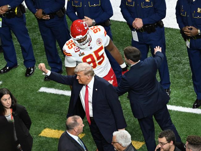 The president walks the sidelines before the start of the game. Picture: AFP