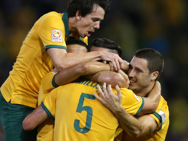 Australia's Jason Davidson celebrates with team mates after scoring a goal during the Asian Cup Semi Final between Australia and UAE at Hunter Stadium , Newcastle .Picture Gregg Porteous