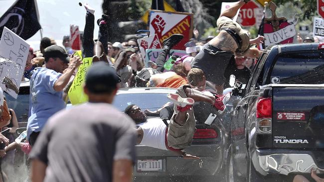 White nationalist James Alex Fields drives through a crowd of protesters, killing Heather Heyer and injuring dozens of others. (Pic: Ryan M. Kelly/AP)