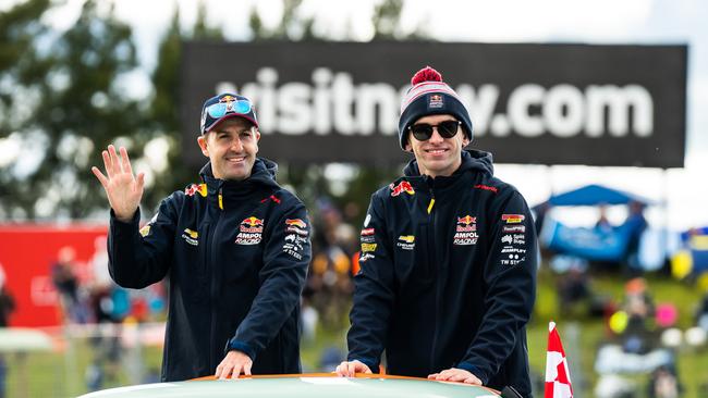 Jamie Whincup driver of the #88 Red Bull Ampol Racing Holden Commodore ZB and Broc Feeney driver of the #88 Red Bull Ampol Racing Holden Commodore ZB wave to fans during drivers parade for the Bathurst 1000, which is race 30 of 2022 Supercars Championship Season at Mount Panorama on October 09, 2022 in Bathurst, Australia. (Photo by Daniel Kalisz/Getty Images)