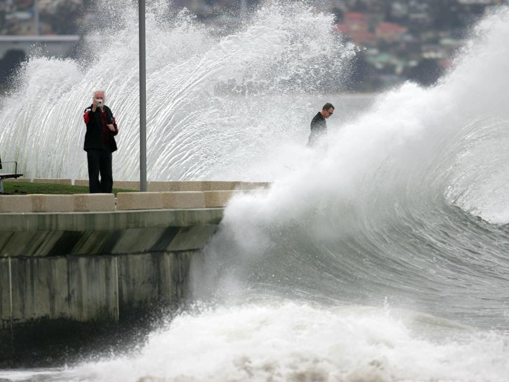 Winter Weather, wild, wet and windy in Tasmania, waves crash into the seawall at Sandy Bay's Nutgrove Beach in 2011.