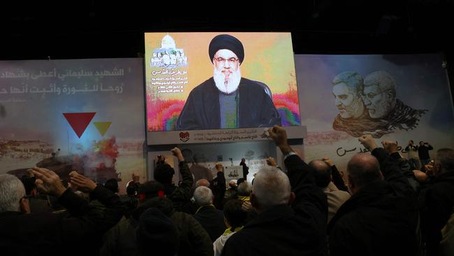 People watch the televised speech of Hassan Nasrallah to mark the anniversary of the killing of slain top Iranian commander Qassem Soleimani. Picture: AFP