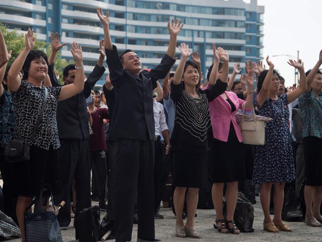 North Koreans react as they watch the televised announcement in Pyongyang that the country has successfully tested a hydrogen bomb. Picture: Kim Won-Jin/AFP