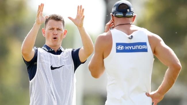 Carlton coach Brendon Bolton speaks to his assistant coaches at pre-season training session.