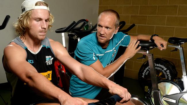 Port Adelaide Power offering the full "inner sanctum" club experience to up to 30 students in a new short course on high performance training. Part of partnership with UniSA. Course launching Friday. Pics with PAFC fitness guru Darren Burgess putting Billy Frampton through his paces on the equipment in the training centre at Alberton Oval. Picture Campbell Brodie.