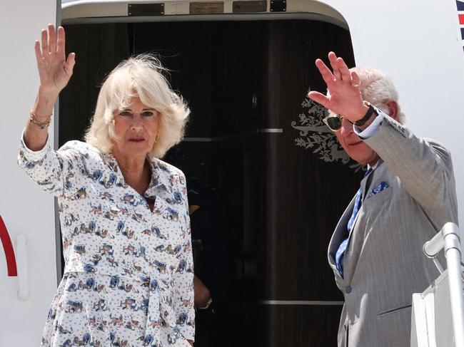 Britain's King Charles III and Queen Camilla wave as they depart from Sydney Airport in Sydney on October 23, 2024, after a six-day royal visit to Sydney and Canberra. (Photo by David GRAY / AFP)